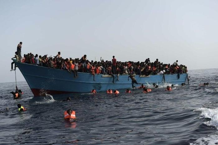Migrants wait to be rescued in the Mediterranean Sea about 12 nautical miles north of Libya on October 4, 2016