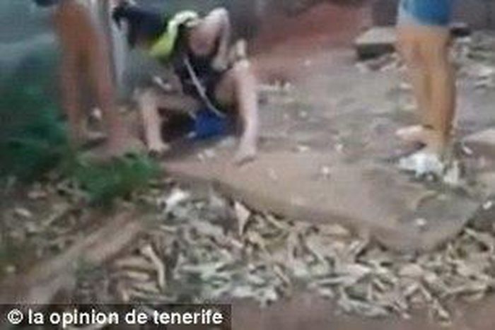 The victim is being hit with a stick