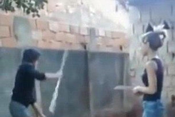 The victim is being hit with a stick