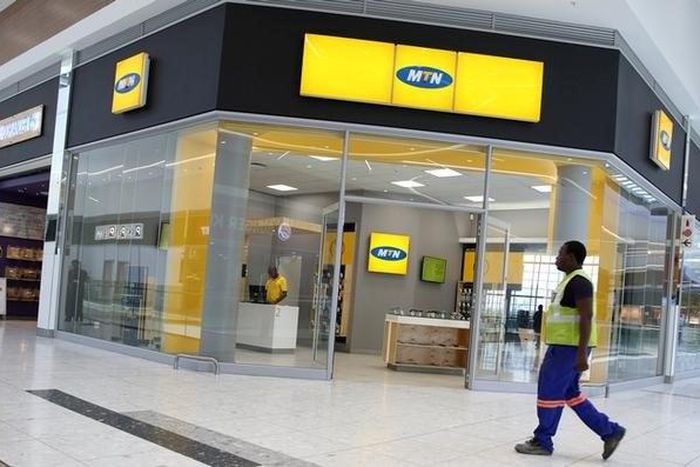 A worker walks past an outlet of South Africa's MTN Group in Johannesburg, South Africa, February 23, 2016.