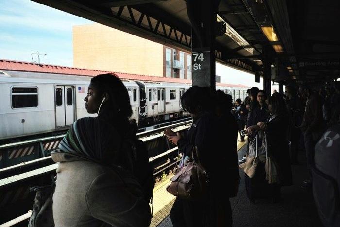 Morning commuters wait for their trains at a station in New York on May 11, 2016