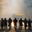 Police officers wearing riot gear block a road during protests after police fatally shot Keith Lamont Scott in the parking lot of an apartment complex in Charlotte, North Carolina, U.S. September 20, 2016.