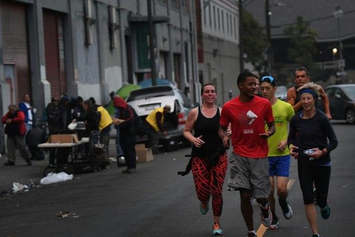 Members of the Midnight Runners team, which is made up mostly of recovering addicts and homeless people, run through the streets of Skid Row in Los Angeles