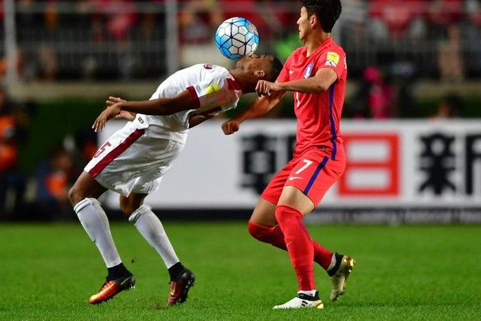 South Korea's Son Heung-Min (R) fights for the ball with Qatar's Pedro Correia (L) during their 2018 World Cup qualifying match in Suwon, south of Seoul, on October 6, 2016