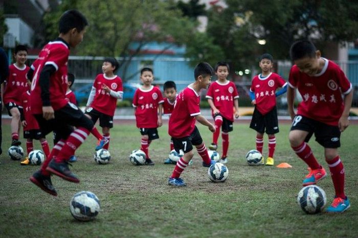 Children attend a football training session in the suburbs of Guangzhou in southern China's Guangdong province