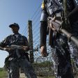 An armed Myanmar border police patrol along the river dividing Myanmar and Bangladesh border located in Maungdaw, Rakhine State on October 15, 2016