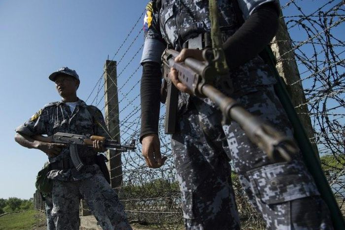 An armed Myanmar border police patrol along the river dividing Myanmar and Bangladesh border located in Maungdaw, Rakhine State on October 15, 2016