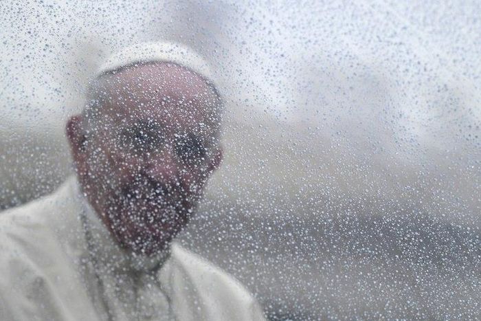 Pope Francis stands in the popemobile in St Peter's Square in the Vatican