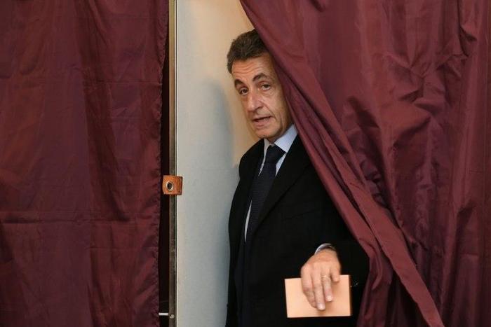 Former French president and candidate for the right-wing Les Republicains (LR) party primary Nicolas Sarkozy leaves a polling booth as he votes in Paris, on November 20, 2016