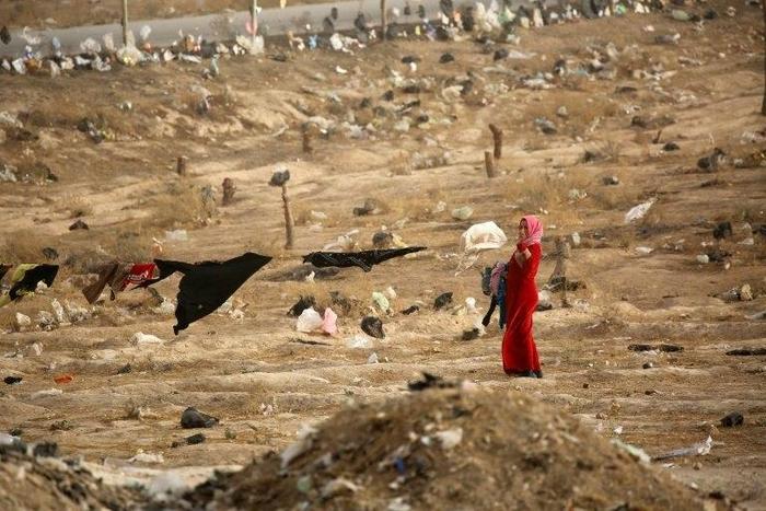 An Iraqi refugee from Mosul hangs up laundry at the UN-run al-Hol refugee camp in Syria's Hasakeh province, on October 31, 2016