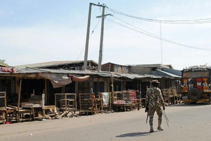 A soldier patrols around a market in Maiduguri, Nigeria, on December 11, 2016