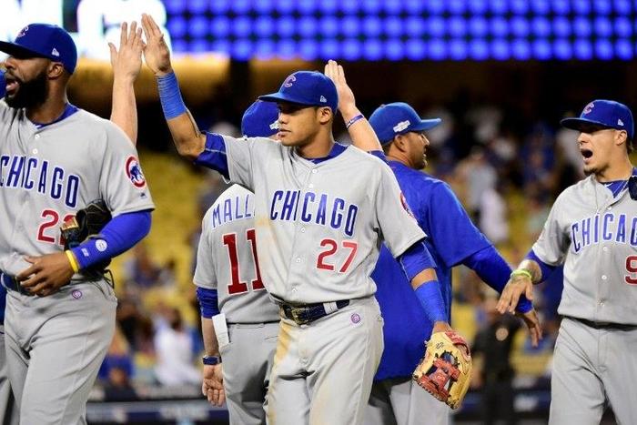 Addison Russell of the Chicago Cubs celebrates with teammates after the Cubs won 8-4 against the Los Angeles Dodgers, in game five of the NL Division Series, at Dodger Stadium in Los Angeles, California, on October 20, 2016