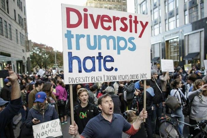 A man shouts slogans during a protest against US President-elect Donald in front of Trump Tower in New York on November 19, 2016