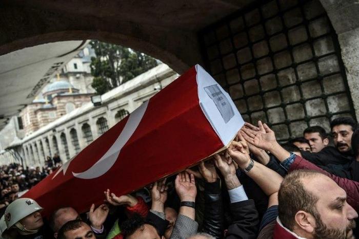 Mourners carry the coffin of Turkish police officer Hasim Usta on December 12, 2016, who was killed in the blasts outside Besiktas' Vodafone Arena football stadium in Istanbul two days earlier