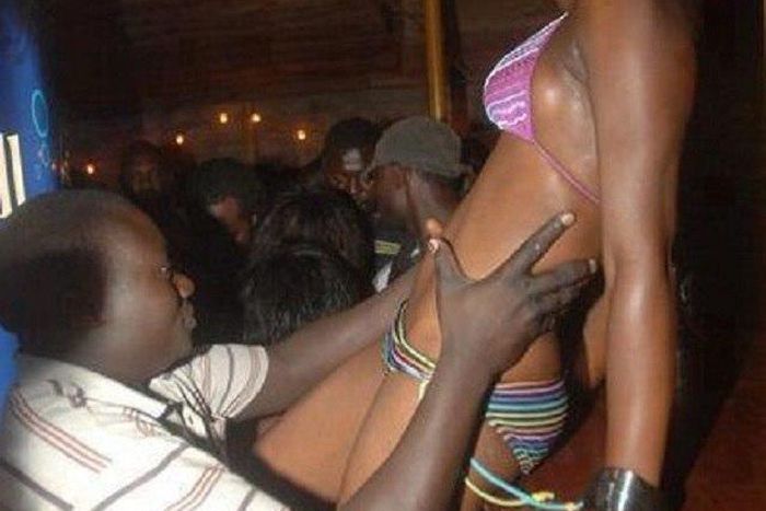 A man is seen holding a half dressed lady.