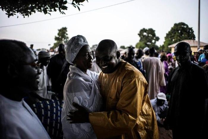 Gambian opposition figure Isatou Touray (L) greets the flag-bearer of the coalition of seven opposition political parties, Adama Barrow, at a gathering in Jambur on November 26, 2016 ahead of December 1 presidential elections