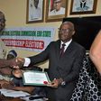 Godwin Obaseki receiving his certificate of return at the INEC office