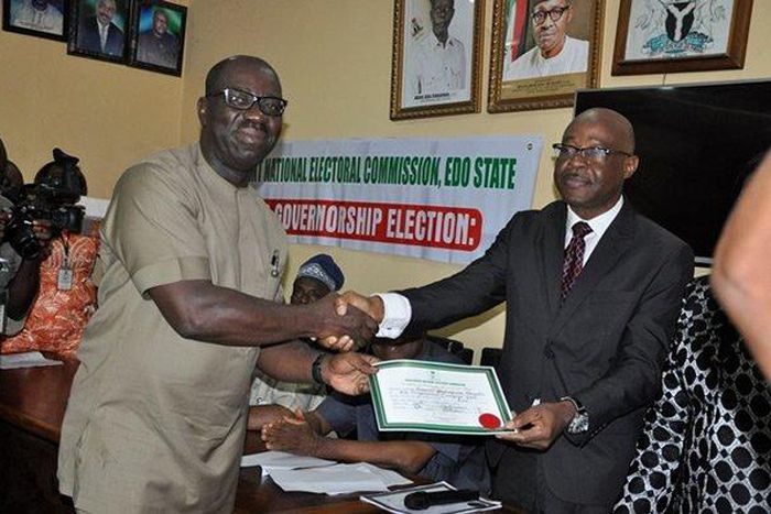 Godwin Obaseki receiving his certificate of return at the INEC office