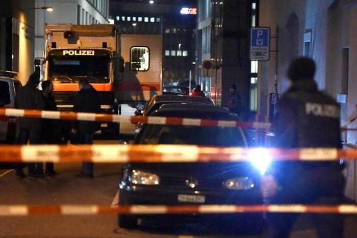 Swiss police are seen behind a police cordon outside a Muslim prayer hall, central Zurich, on December 19, 2016