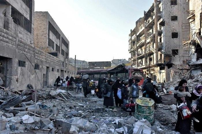 Syrian residents fleeing the violence in the eastern rebel-held parts of Aleppo evacuate from their neighbourhoods through the Bab al-Hadid district