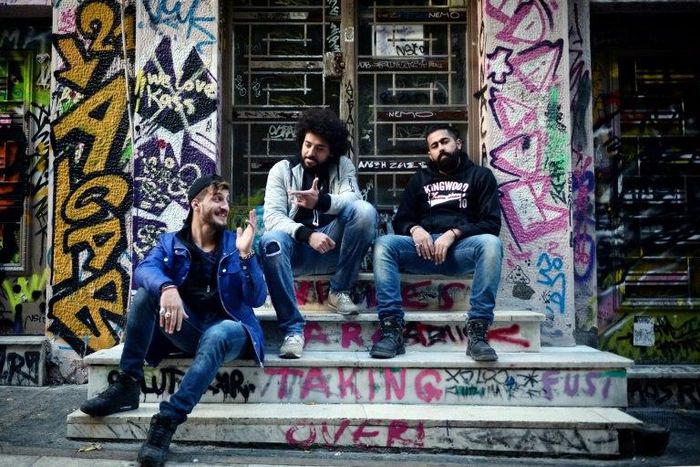 Syrian refugees from Aleppo (from L) Abu Habib, 24, Majd Ahmad, 26, and Abu Rmosh, 30, seen at the 'alternative' neighborhood of Exarchia in Athens, home to many Syrian refugees in NGO-leased apartments or in squats run by anarchist movements