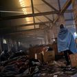 A migrant walks trough a makeshift shelter at an abandoned warehouse in Belgrade, Serbia, on December 8, 2016