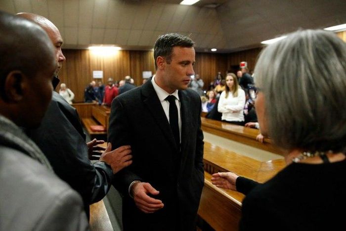 South African Paralympian athlete Oscar Pistorius (C) speaks with relatives as he leaves the High Court in Pretoria, on July 6, 2016
