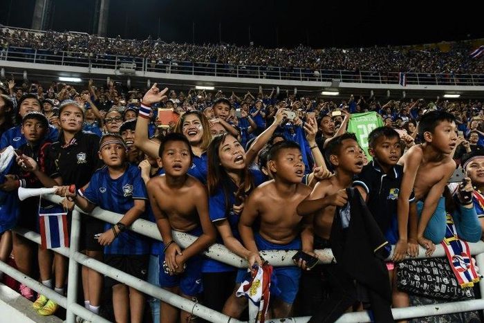 Local football fans celebrate after Thailand won the AFF Suzuki Cup Final against Indonesia, at Rajamangala Stadium in Bangkok, on December 17, 2016