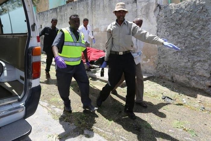 Paramedics carry a civilian wounded following a car bomb claimed by al Shabaab Islamist militants outside the president's palace on a stretcher from the scene of the explosion in the Somali capital of Mogadishu, August 30, 2016.