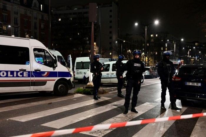 French police officers stand guard at the site where a robber armed with a handgun held several people in a travel agency on the Massena Boulevard, in the Porte d'Italie area in Paris, on December 2, 2016