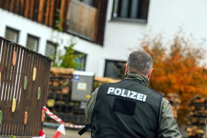 A policeman is pictured on October 19, 2016 in Georgensgmuend, southern Germany, in front of a house of a member of the so-called Reichsbuerger movement