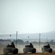 Turkish Army tanks drive to the Syrian Turkish border town of Jarabulus on August 25, 2016