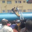 Two men are seen bringing out the corpse of Emmanuel from the petrol tanker.