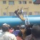 Two men are seen bringing out the corpse of Emmanuel from the petrol tanker.