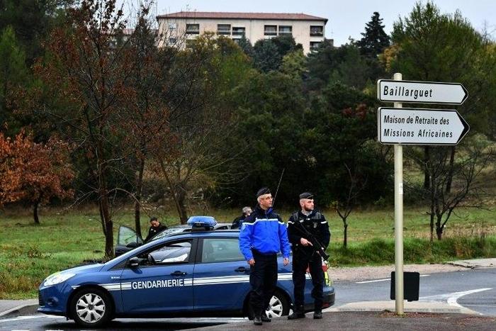 French police stand guard on a road near a retirement home for Christian missionaries in Montferrier-sur-Lez, southern France, on November 25, 2016