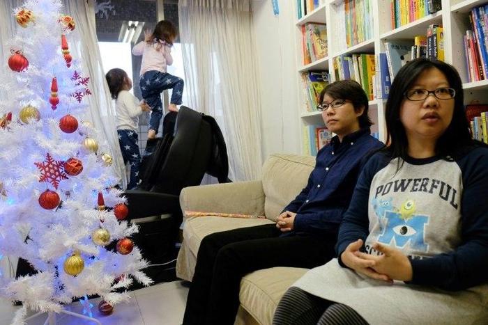 Same-sex parents Hope Chen (R), 37, and Zoro Wen (2nd R), 34, with their twin daughters want legal recognition of their relationship