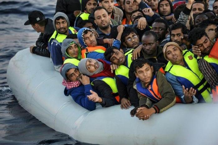 Migrants and refugees wait to be rescued off the Libyan coast on November 5, 2016