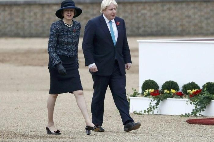 Britain's Prime Minister Theresa May (L) and British Foreign Secretary Boris Johnson arrive to take part in a ceremonial welcome at Horse Guards Parade