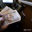 A teller counts Kenya shilling notes inside the cashier's booth at a forex exchange bureau in Kenya's capital Nairobi, April 20, 2016. REUTERS/Thomas Mukoya