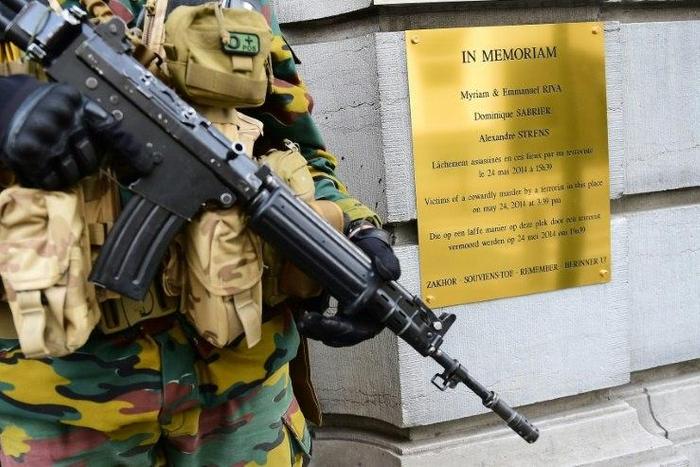 A Belgium soldier stands guard in front the entrance of the Jewish Museum of Belgium, beside a memorial plate to the victims of a shooting terrorist attack, in Brussels, on May 19, 2015