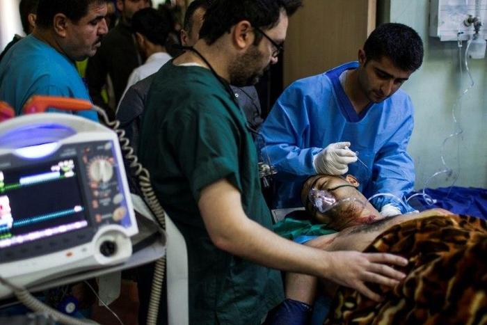A wounded man is treated at a hospital in Iraq's Erbil after a triple car bombing at a market in Gogjali on December 22, 2016