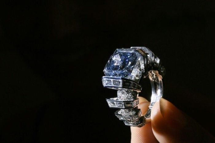 A model presents the "The Sky Blue Diamond," a fancy, vivid blue diamond ring created by Cartier, during a press preview by Sotheby's Auction House on November 9, 2016 in Geneva