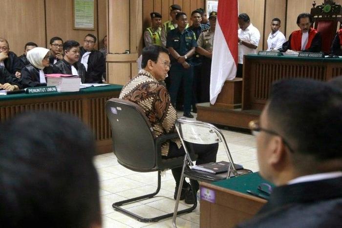 Jakarta Governor Basuki Tjahaja Purnama (C), is accused of insulting the Koran