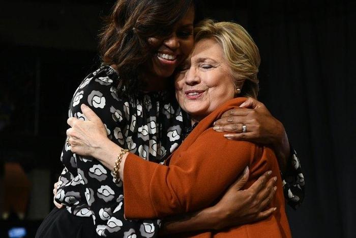 US First Lady Michelle Obama (L) embraces Democratic presidential nominee Hillary Clinton during a campaign rally in Winston-Salem, North Carolina on October 27, 2016
