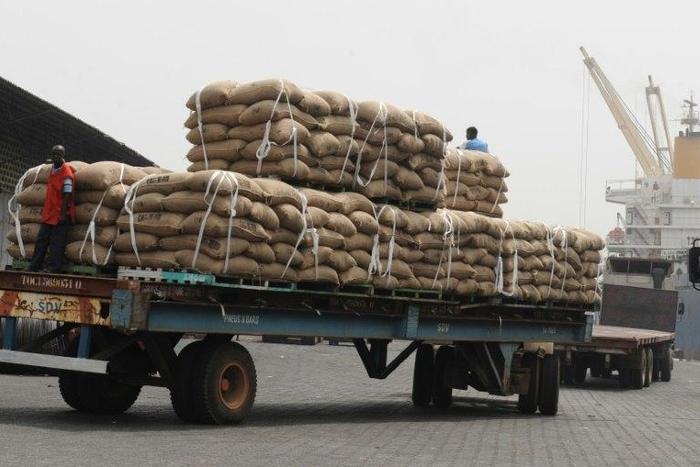 In January 2011, an Ivorian worker stands on a truck carrying bags of cocoa beans, 15 percent of Ivory Coast's GDP and more than 50 percent of its export earnings, according to the World Bank