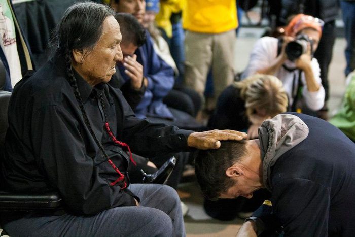 Leonard Crow Dog lays his palm on Wes Clark Jr.