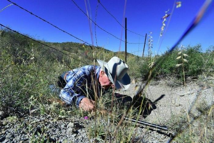 Cattle rancher Jim Chilton demonstrates how easy it is to cross the US-Mexico border on part of his 50,000 acre ranch southeast of Arivaca, Arizona