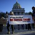 Protestors demonstrate outside the Pennsylvania Capitol Building in Harrisburg on December 19, 2016