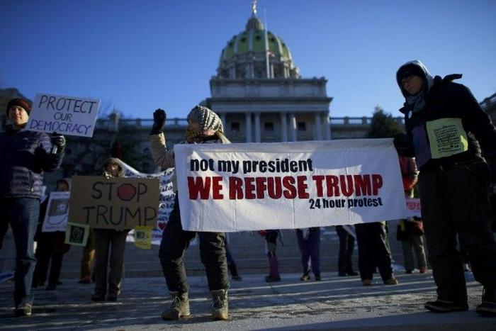 Protestors demonstrate outside the Pennsylvania Capitol Building in Harrisburg on December 19, 2016