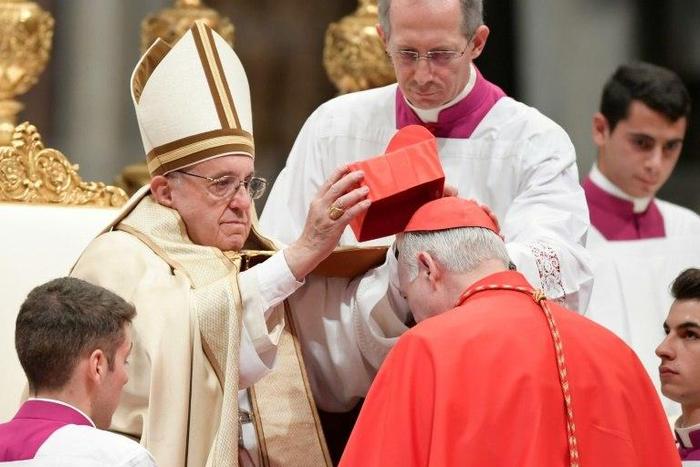 Archbishop of Tlanepantla in Mexico Carlos Aguiar Retes kneels before Pope Francis to pledge allegiance and become cardinal, during a consistory at Peter's basilica